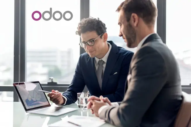 Odoo logo is visible as two business professionals in suits review data on a tablet during a meeting in office, suggesting a discussion about ERP software or business.